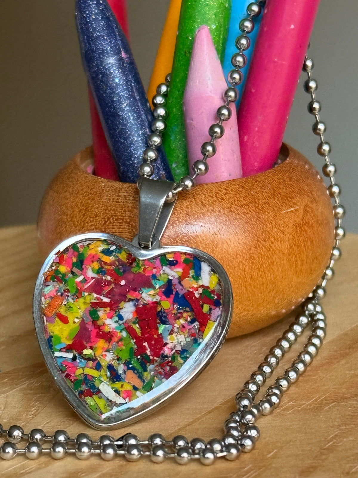 Large multicolor Viva crayon filled heart shaped stainless steel pendant. Crayon jewelry by Crayonfetti, mother-daughter based in Atlanta.
