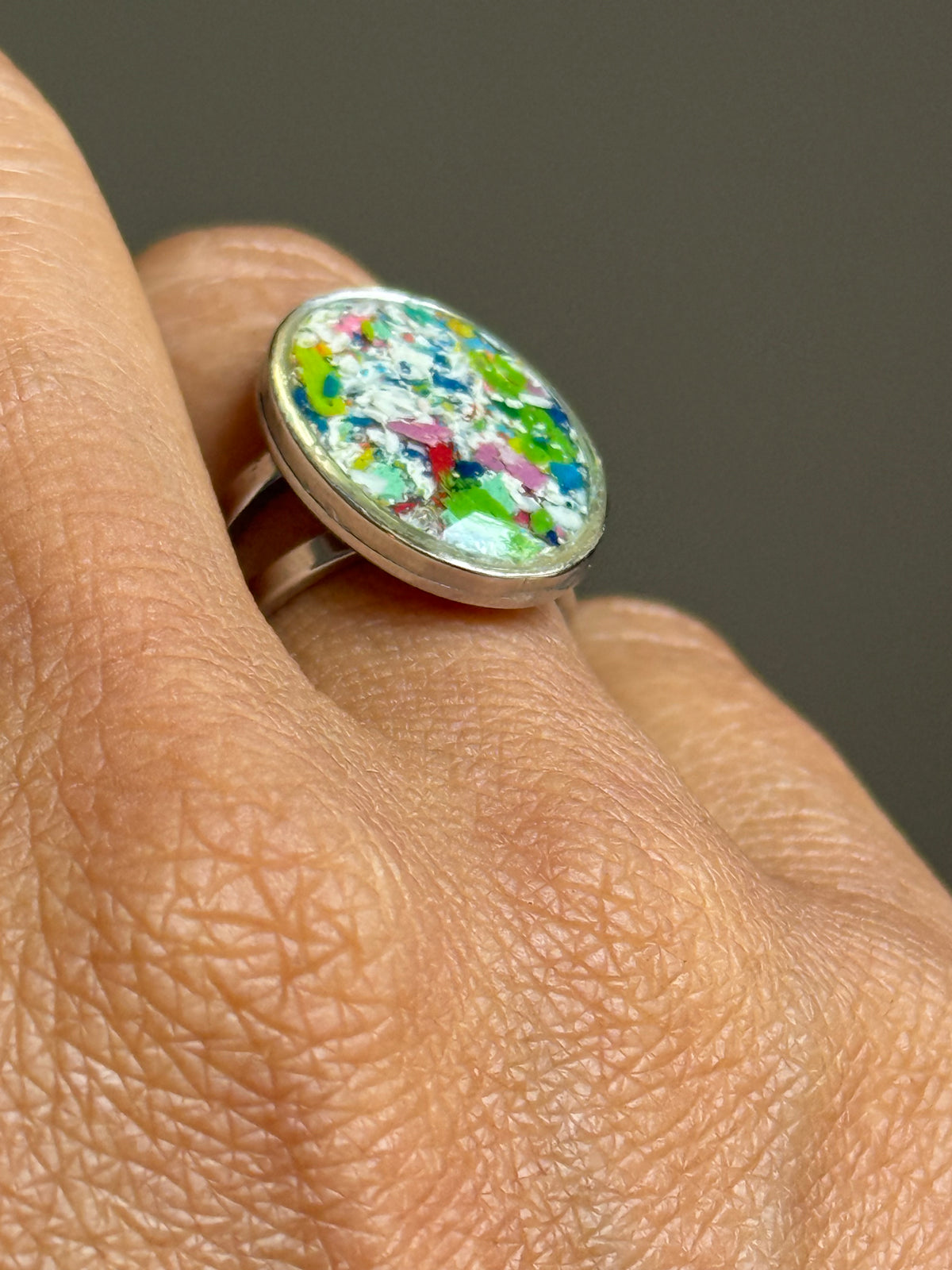 Handcrafted oval ring made with recycled crayons, featuring a polished and sophisticated silhouette. Made by mother-daughter studio in Atlanta, GA. It's crayon jewelry.