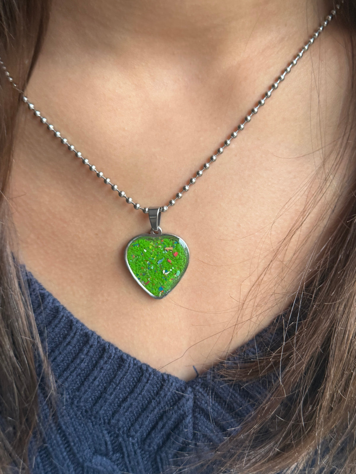 Spring green crayon filled heart shaped stainless steel pendant. Crayon jewelry by Crayonfetti, mother-daughter based in Atlanta.