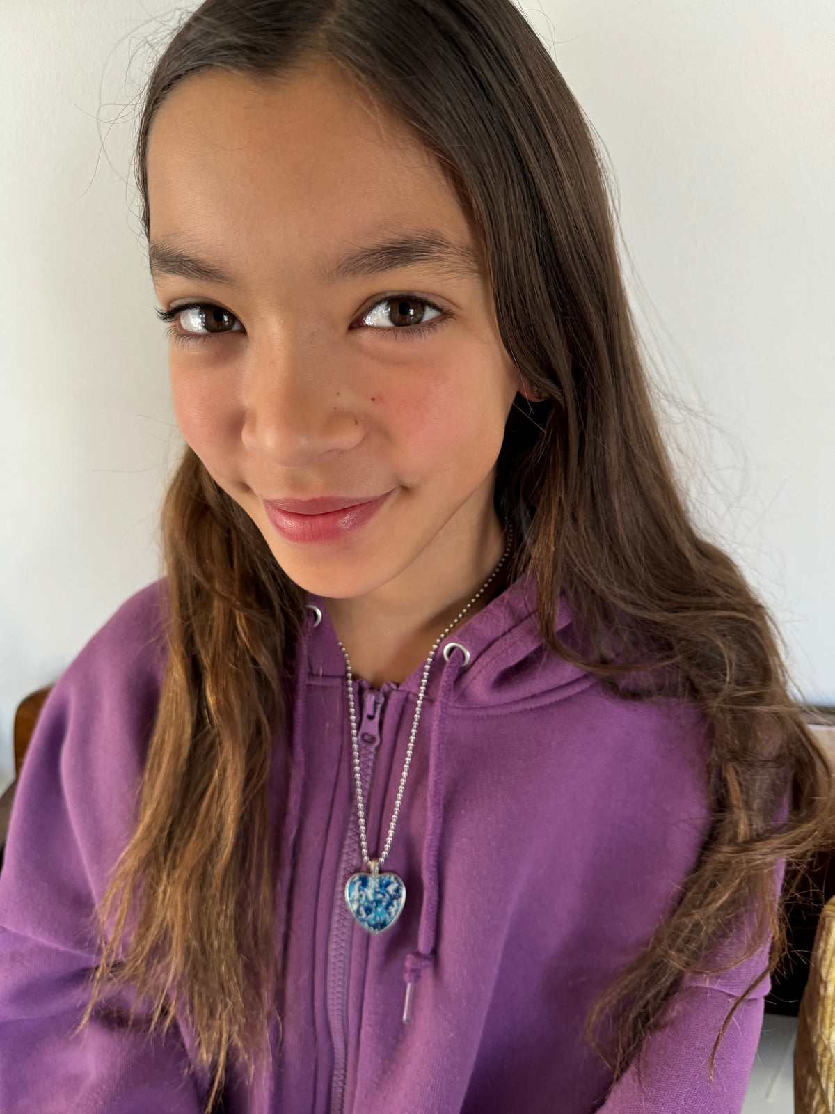 Blue and white crayon filled heart shaped stainless steel pendant. Crayon jewelry by Crayonfetti, mother-daughter based in Atlanta.