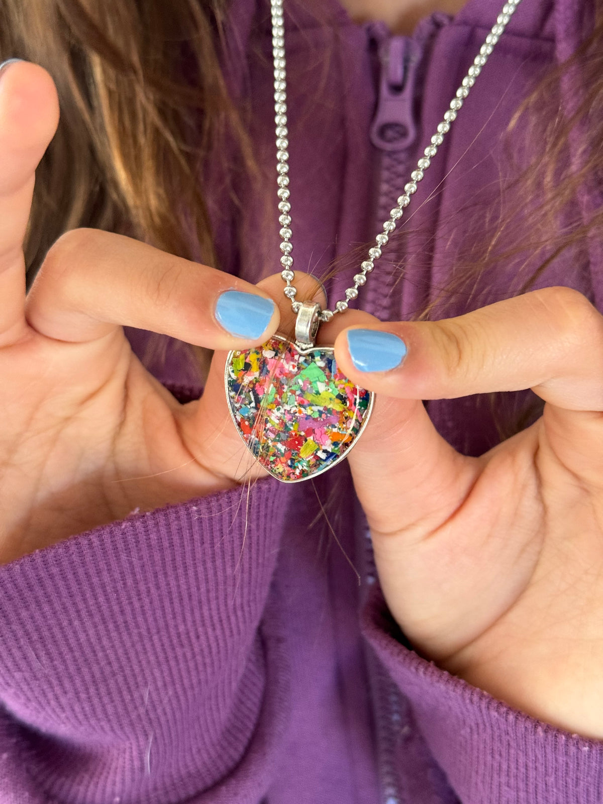 Large multicolor Viva crayon filled heart shaped stainless steel pendant. Crayon jewelry by Crayonfetti, mother-daughter based in Atlanta.