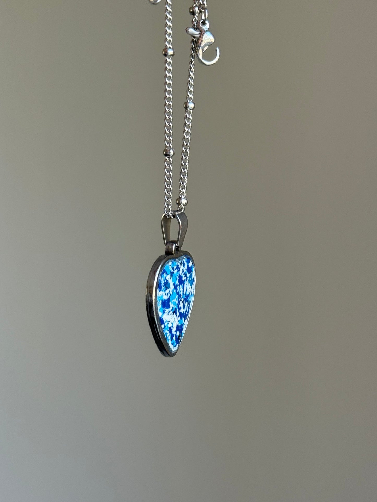 Blue and white crayon shavings heart pendant upcycled handmade wearable art. Crayon jewelry by Crayonfetti, mother-daughter based in Atlanta.