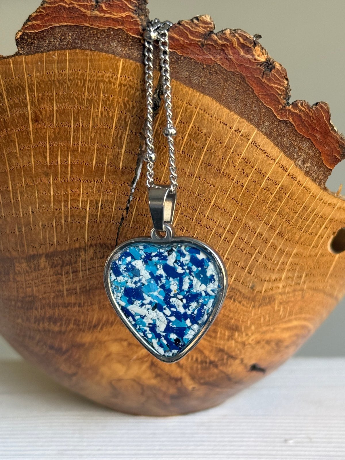 Blue and white crayon shavings heart pendant necklace handmade statement jewelry. Crayon jewelry by Crayonfetti, mother-daughter based in Atlanta.
