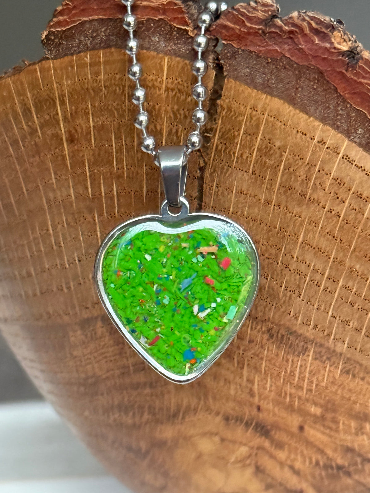 Spring green crayon filled heart shaped stainless steel pendant. Crayon jewelry by Crayonfetti, mother-daughter based in Atlanta.