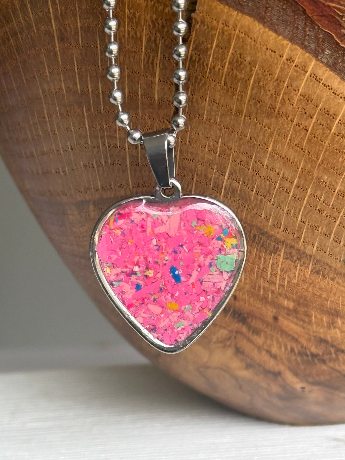 Rose pink warm-toned crayon shavings heart pendant handmade jewelry. Crayon jewelry by Crayonfetti, mother-daughter based in Atlanta