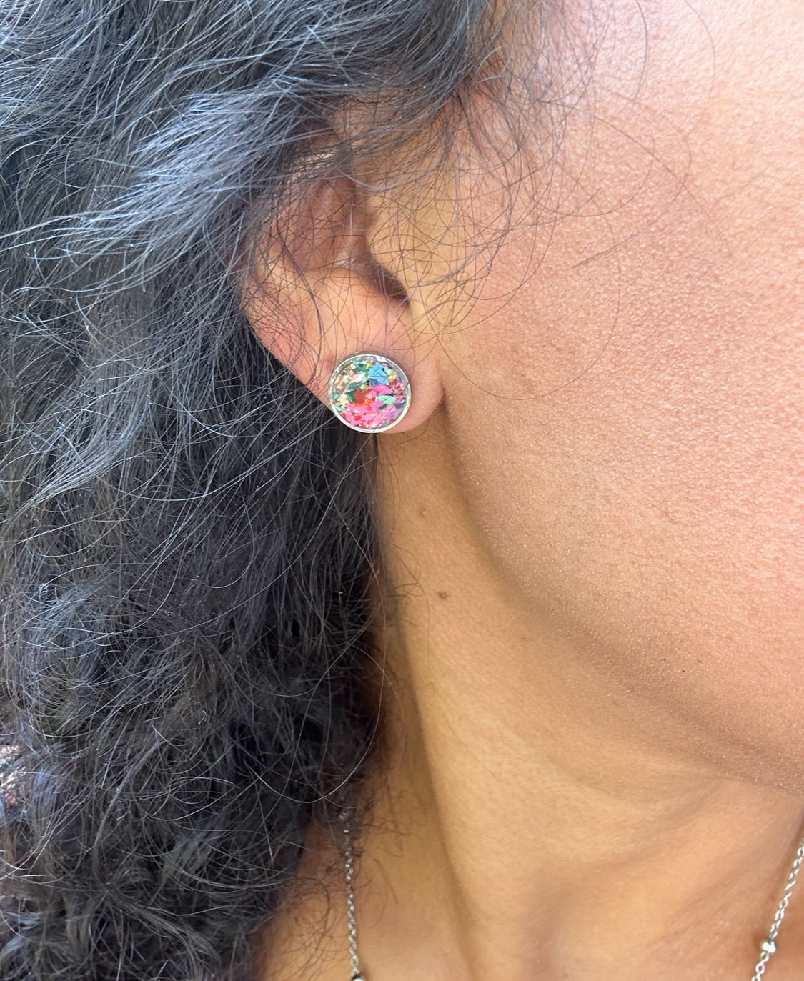 Colorful round crayon jewelry studs in a stainless steel frame