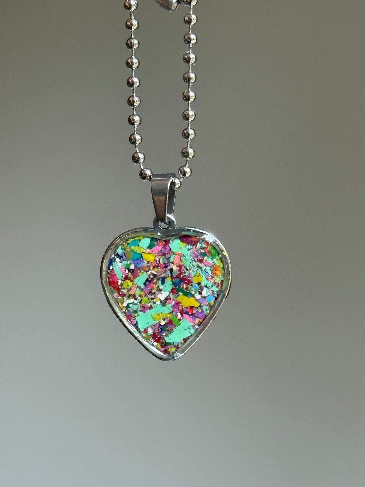 Colorful heart pendant made from recycled crayons, unique crayon jewelry handcrafted by mother daughter duo