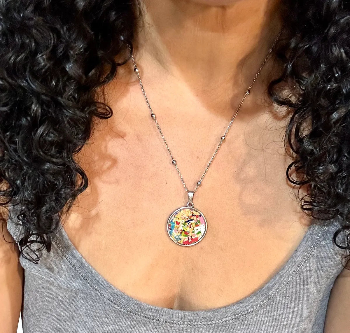 Stainless steel round pendant filled with crayon shavings by crayonfetti. Crayon jewelry.  Crayon gifts. Teacher gift idea.  Crayonpendants.  Crayon pendants.