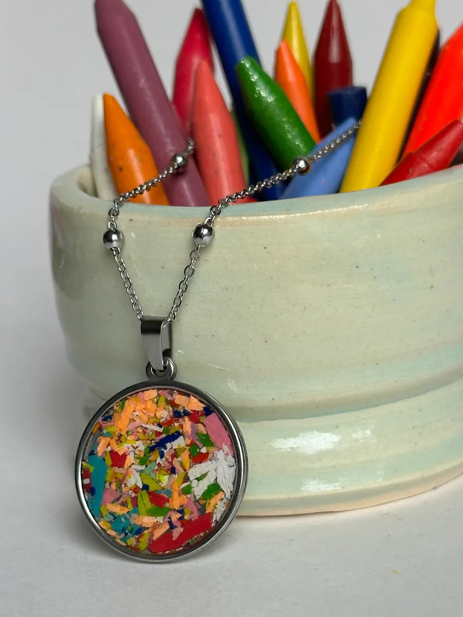 Stainless steel round pendant filled with crayon shavings by crayonfetti. Crayon jewelry.  Crayon gifts. Teacher gift idea.  Crayonpendants.  Crayon pendants.