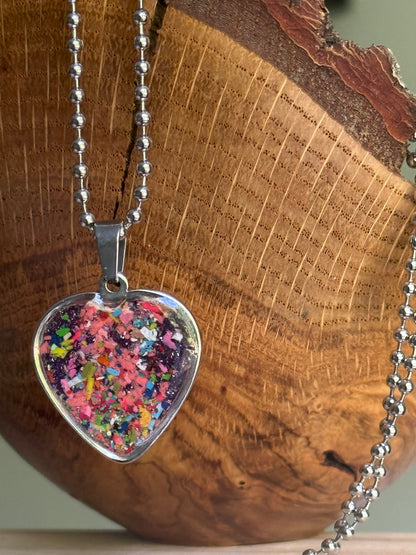 pink purple crayon shavings heart necklace worn as styled statement jewelry. Crayon jewelry by Crayonfetti, mother-daughter based in Atlanta.