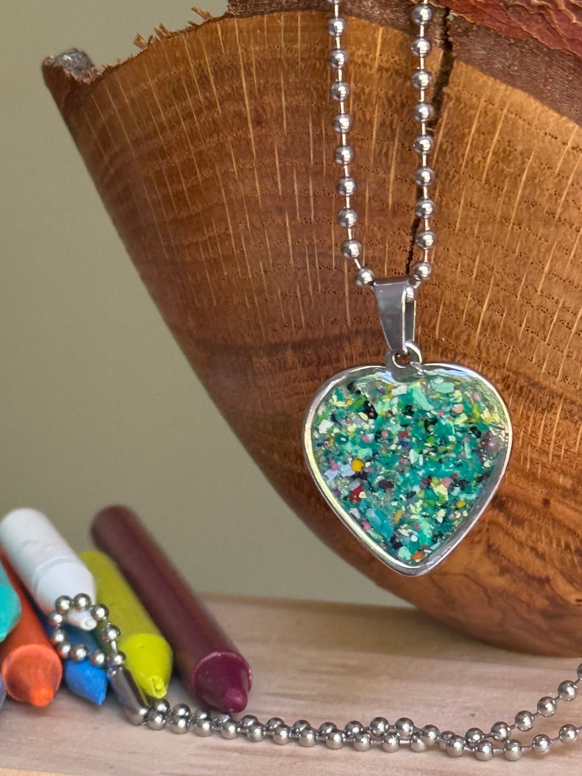 green earthy crayon shavings heart necklace handmade statement jewelry. Crayon jewelry by Crayonfetti, mother-daughter based in Atlanta.