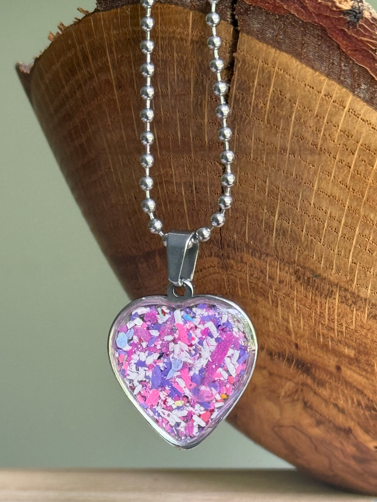 Orchid crayon shavings heart necklace handmade wearable art upcycled jewelry. Crayon jewelry by Crayonfetti, mother-daughter based in Atlanta.