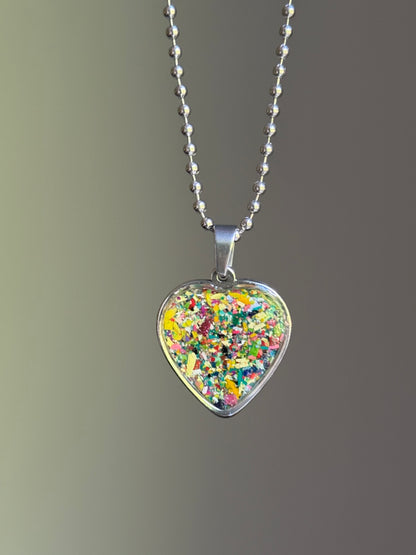 dark-toned crayon shavings heart pendant colorful upcycled necklace. Crayon jewelry by Crayonfetti, mother-daughter based in Atlanta.