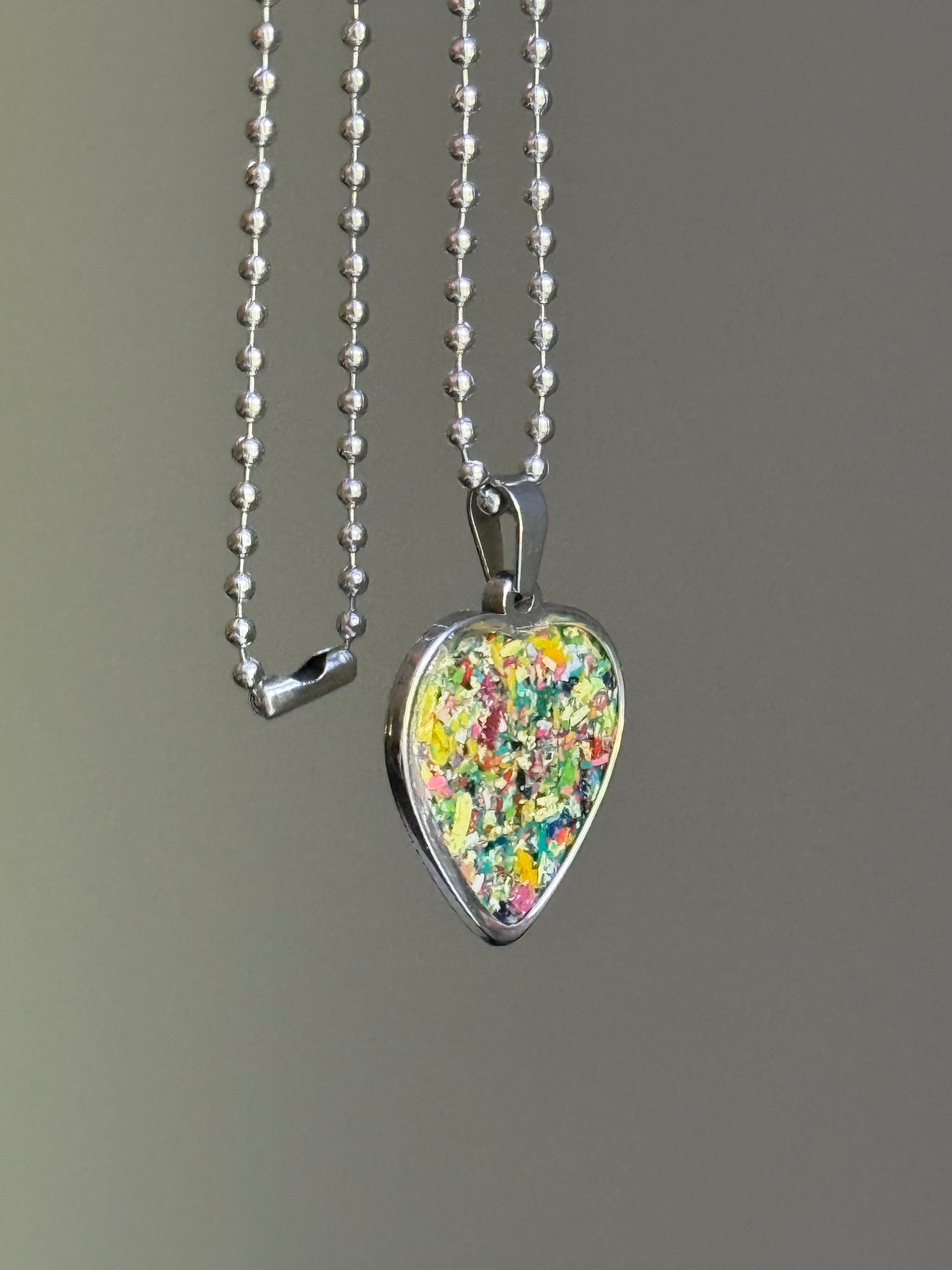 Safe for sensitive skin with durable stainless steel. Each crayon heart pendant holds a unique character. Crayon jewelry by Crayonfetti. 