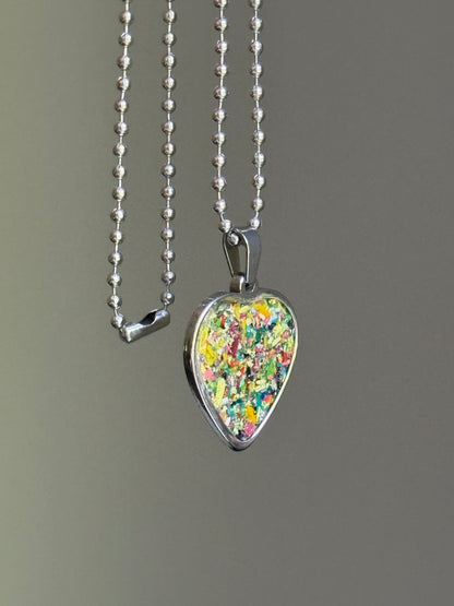 Safe for sensitive skin with durable stainless steel. Each crayon heart pendant holds a unique character. Crayon jewelry by Crayonfetti. 