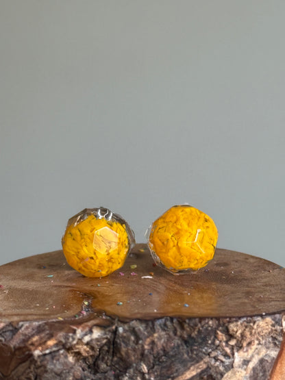 small colorful studs made with recycled crayons in dandelion. Our crayon jewelry are a joyful pop-of-color made from our mother-daughter studio in Atlanta, GA.