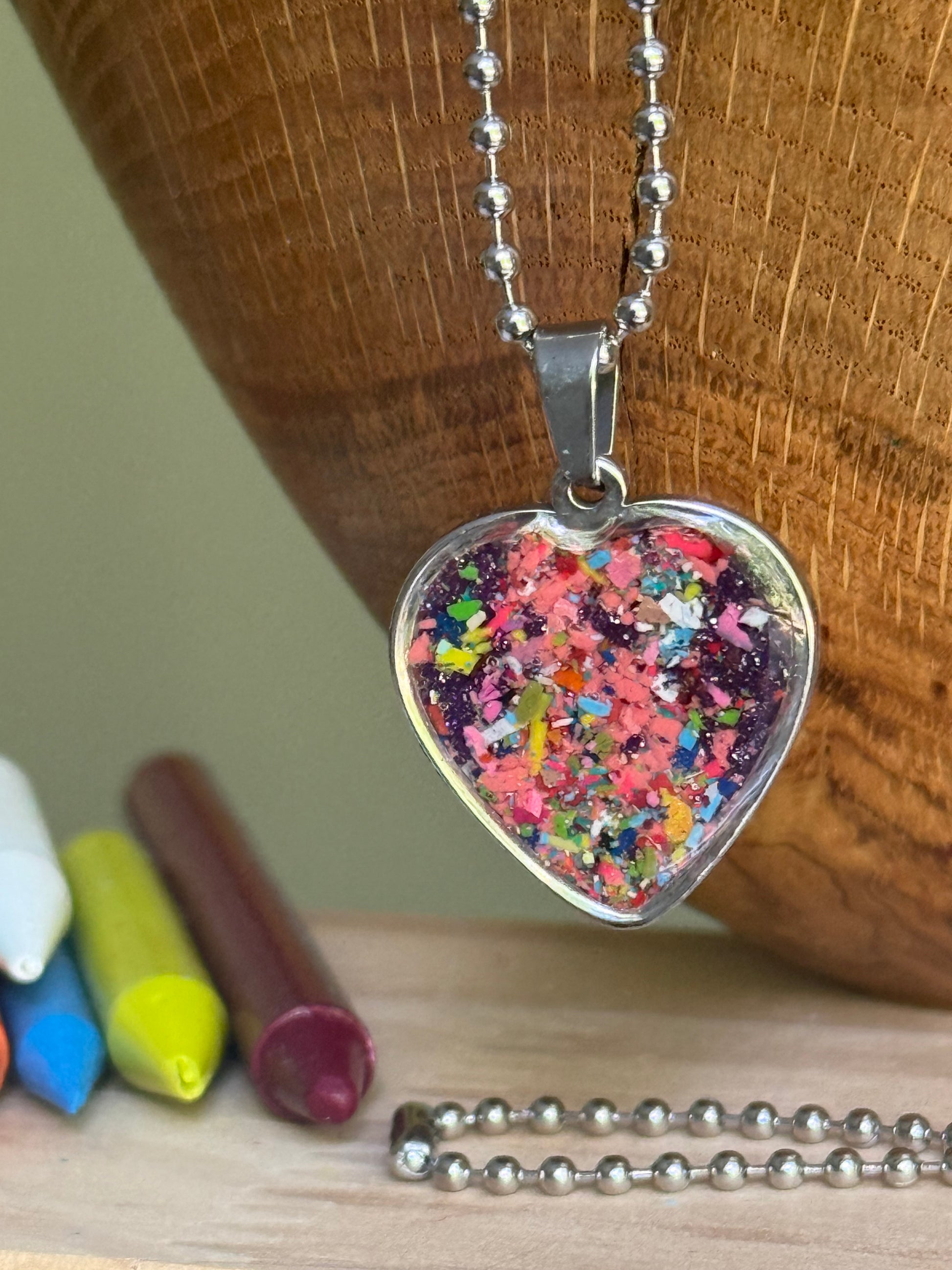 Royal jewel-toned crayon shavings heart necklace handmade statement jewelry. Crayon jewelry by Crayonfetti, mother-daughter based in Atlanta.