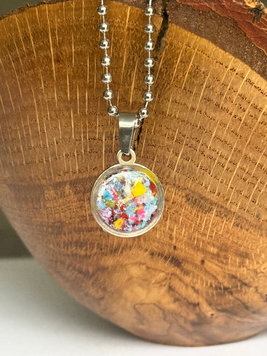Blue, teal, and yellow round stainless steel pendant filled with crayon shavings. Dainty necklace. Crayonfetti crayon jewelry by mother-daughter based in Atlanta, Georgia.