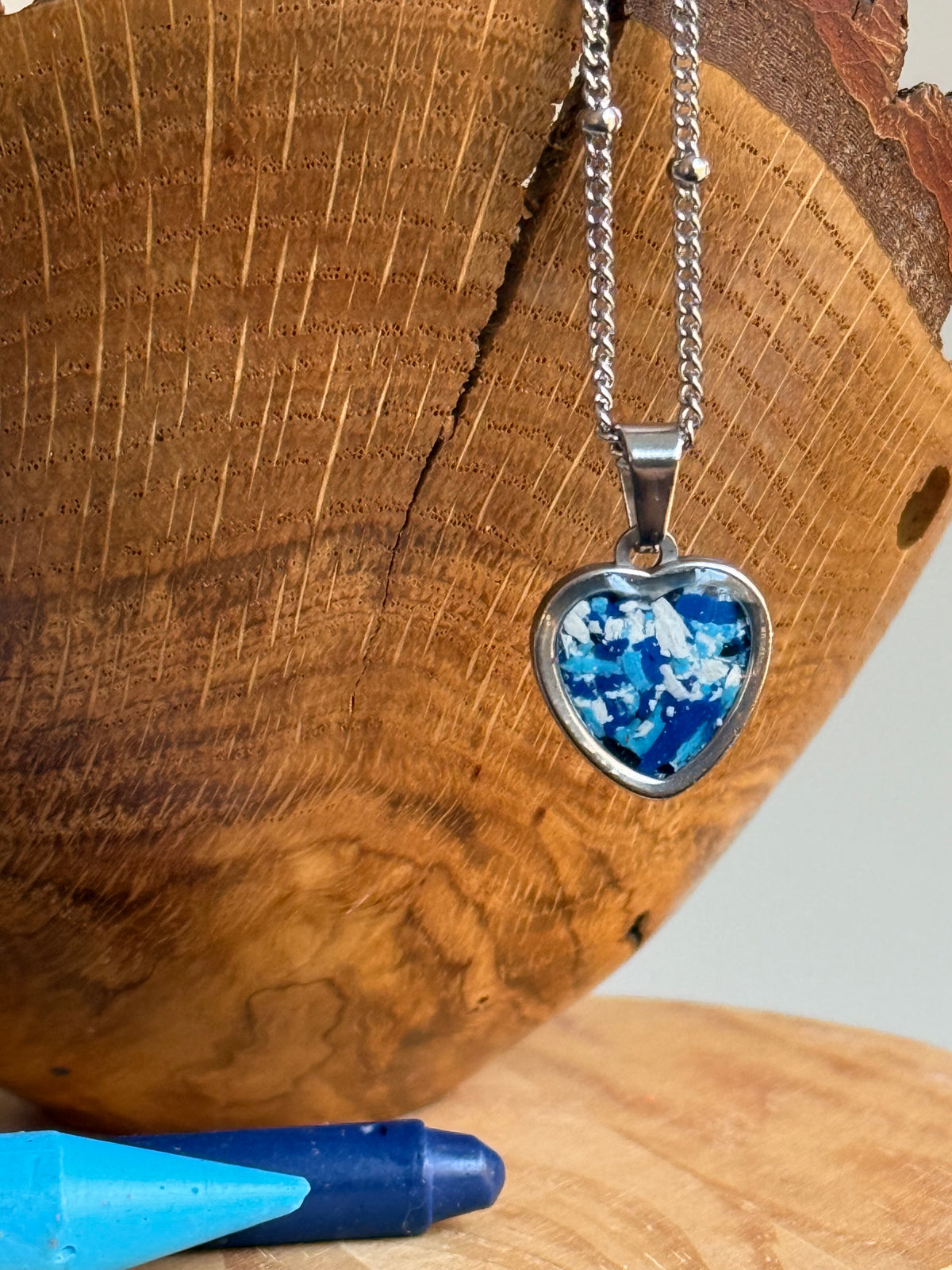 Blue and white small heart stainless steel pendant filled with crayon shavings. Dainty necklace. Crayonfetti crayon jewelry by mother-daughter based in Atlanta, Georgia.