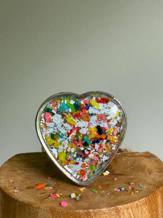 Quarter-sized blue and multicolor heart crayon ring made with recycled crayon jewelry set in stainless steel. It's crayon jewelry by crayonfetti