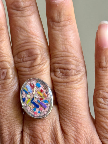 Hand modeling oval ring filled with crayons, by Crayonfetti