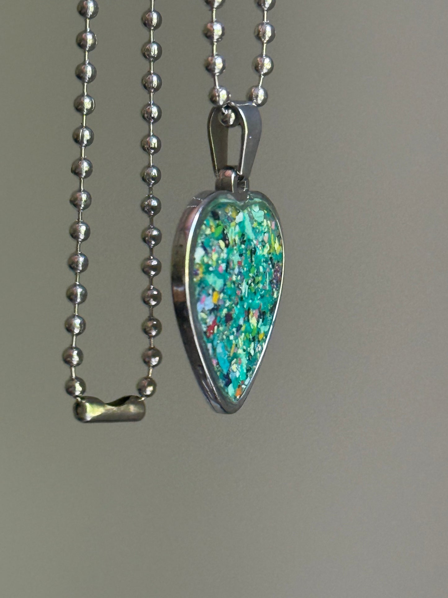 Meadows crayon shavings heart necklace worn as styled statement jewelry. Crayon jewelry by Crayonfetti, mother-daughter based in Atlanta.