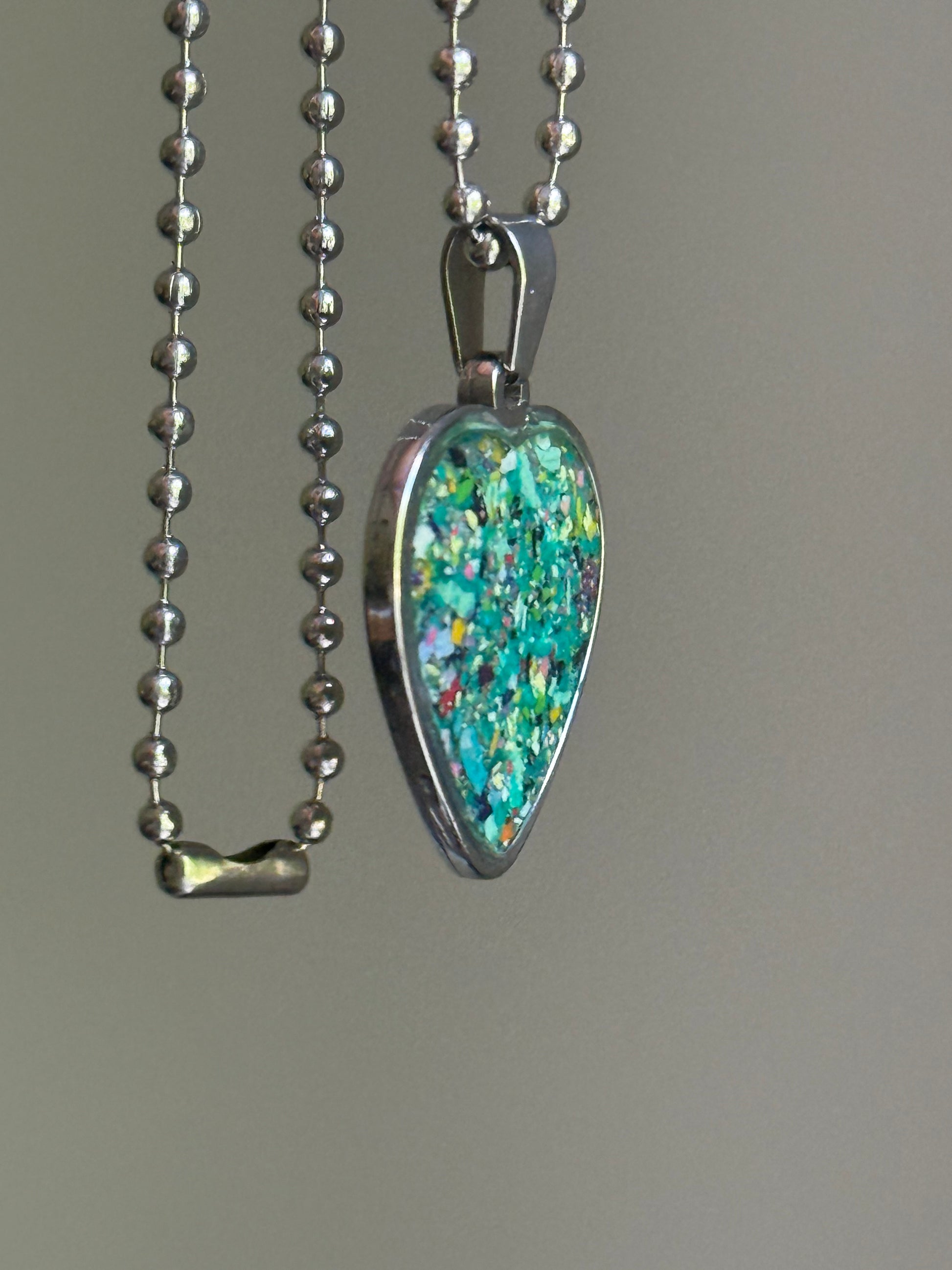Meadows crayon shavings heart necklace worn as styled statement jewelry. Crayon jewelry by Crayonfetti, mother-daughter based in Atlanta.