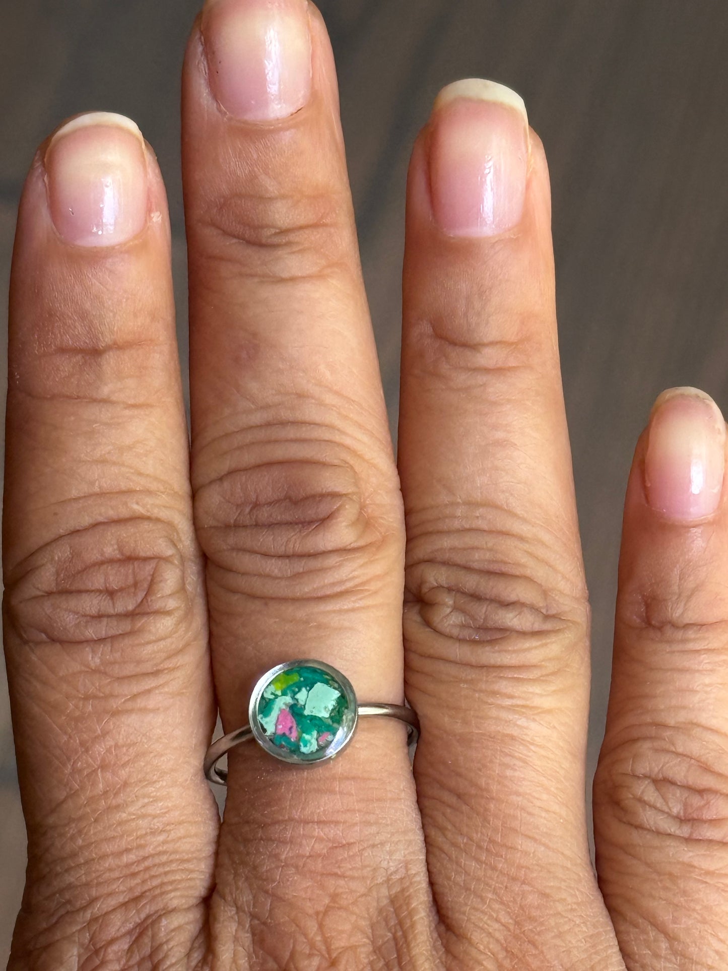 A delicate stainless steel crayon mosaic ring with pink and green watermelon tones