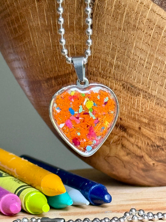 Bright orange crayon heart necklace worn as everyday jewelry, perfect as a colorful handmade gift.
