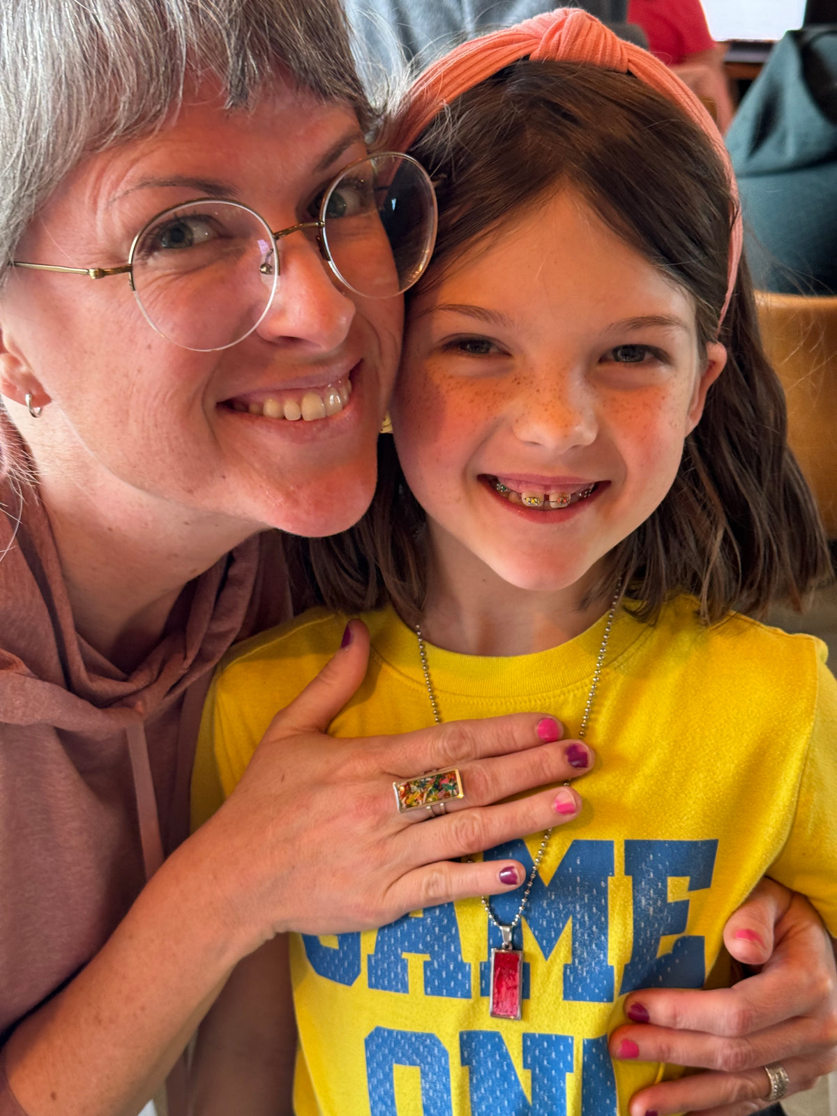teacher wearing crayon jewelry
