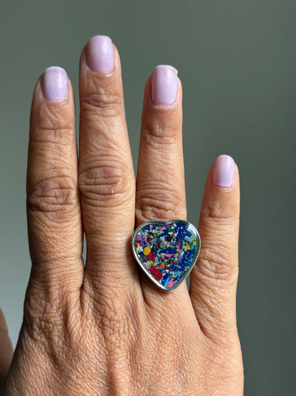Handcrafted large heart-shaped ring made with recycled crayons, featuring lots of navy and cobalt hues. Made by mother-daughter studio in Atlanta, GA.  It's crayon jewelry by crayonfetti.