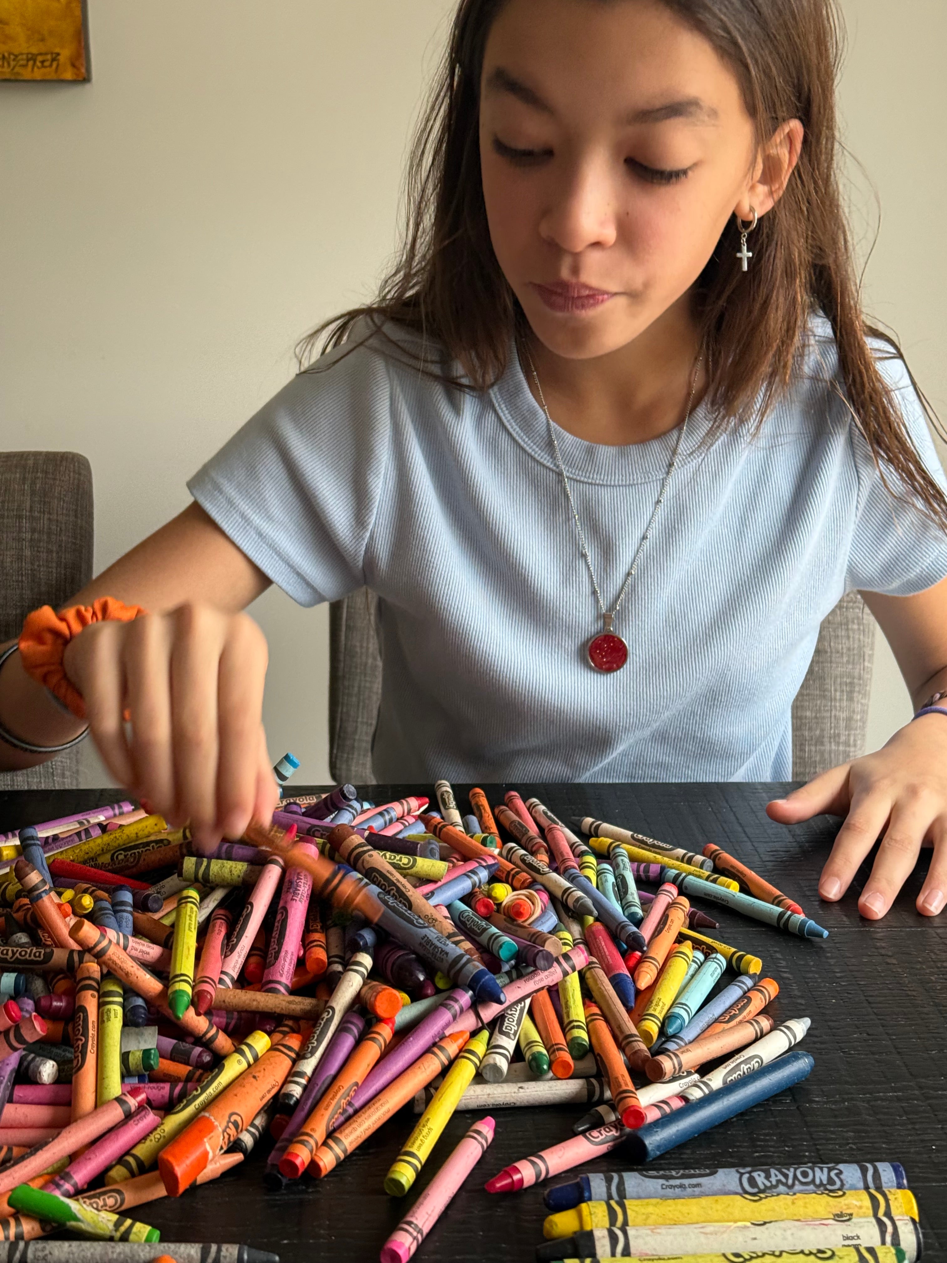 sorting donated crayons to make crayon jewelry