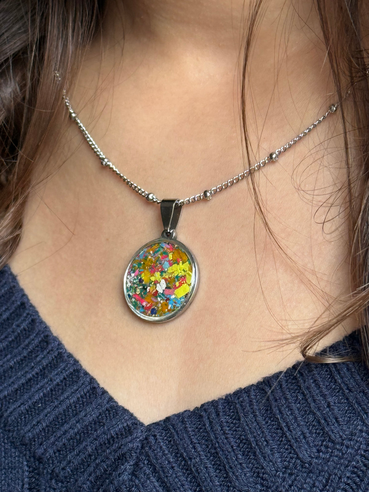 Stainless steel pendant with hand placed crayons.  Crayon Jewelry