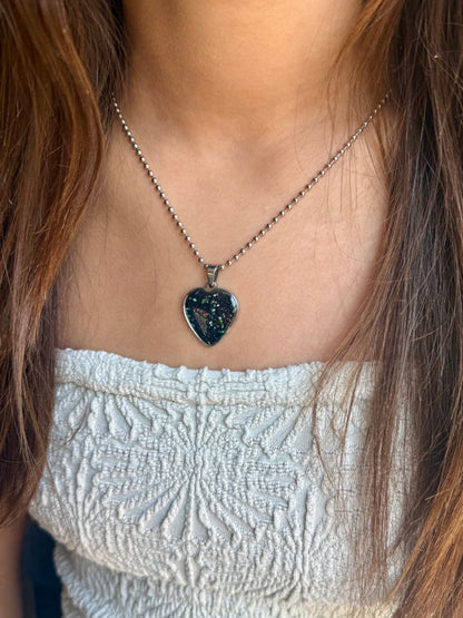 one-of-a-kind black heart pendant made from reclaimed crayon shavings with colorful sprinkle details, handcrafted crayon jewelry.