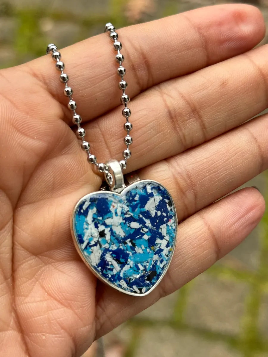 heart pendant filled with blue crayon shavings by crayonfetti