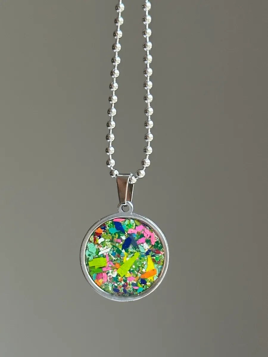 Stainless steel round pendant filled with crayon shavings by crayonfetti. Crayon jewelry.  Crayon gifts. Teacher gift idea.  Crayonpendants.  Crayon pendants.