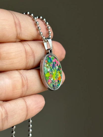 Stainless steel round pendant filled with crayon shavings by crayonfetti. Crayon jewelry.  Crayon gifts. Teacher gift idea.  Crayonpendants.  Crayon pendants.