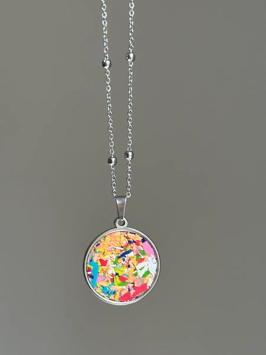 Stainless steel round pendant filled with crayon shavings by crayonfetti. Crayon jewelry.  Crayon gifts. Teacher gift idea.  Crayonpendants.  Crayon pendants.