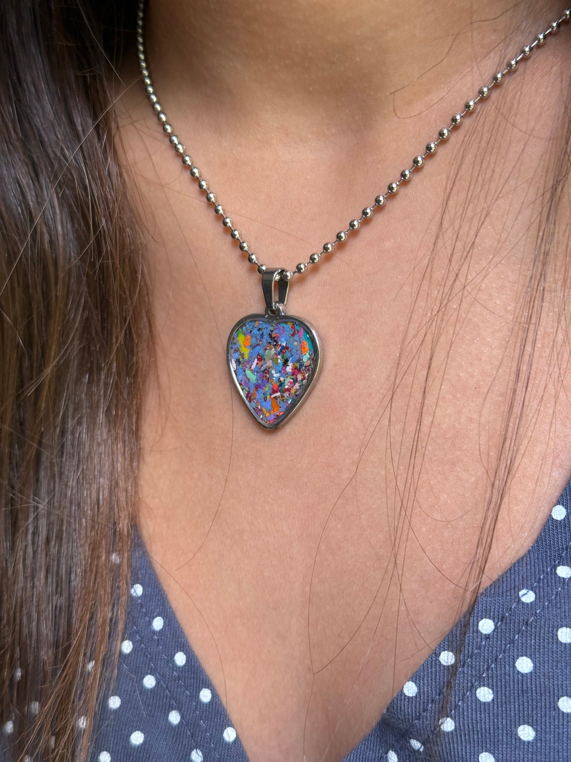 person wearing our crayonfetti heart shaped pendant, crayon jewelry