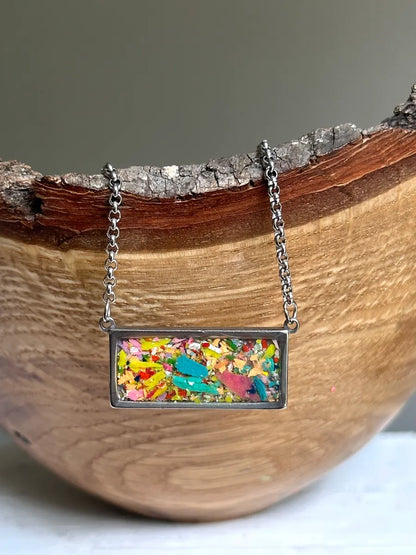 Stainless steel necklace filled with crayon shavings by crayonfetti. Crayon jewelry.  Crayon gifts. Teacher gift idea.  Crayonpendants.  Crayon pendants.