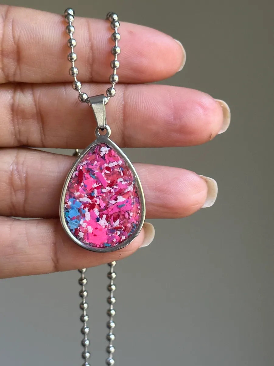 Stainless steel round pendant filled with crayon shavings by crayonfetti. Crayon jewelry.  Crayon gifts. Teacher gift idea.  Crayonpendants.  Crayon pendants.